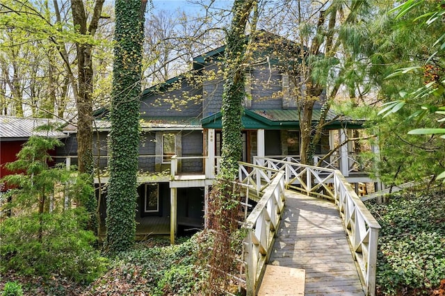 rear view of property with covered porch