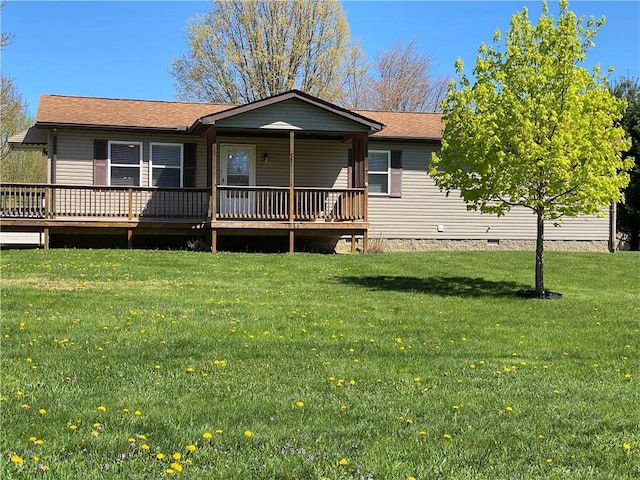 back of house with a yard, crawl space, a wooden deck, and roof with shingles