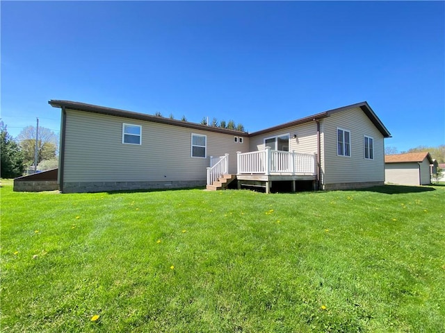 rear view of property with a yard and a deck