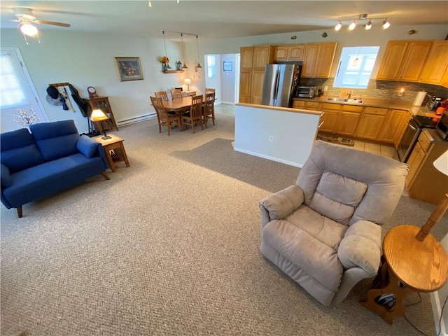 living room featuring a ceiling fan, light carpet, and a baseboard radiator
