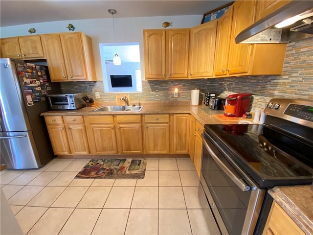 kitchen with under cabinet range hood, light tile patterned flooring, a sink, stainless steel appliances, and tasteful backsplash