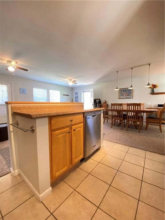 kitchen with light colored carpet, light tile patterned floors, plenty of natural light, and dishwasher