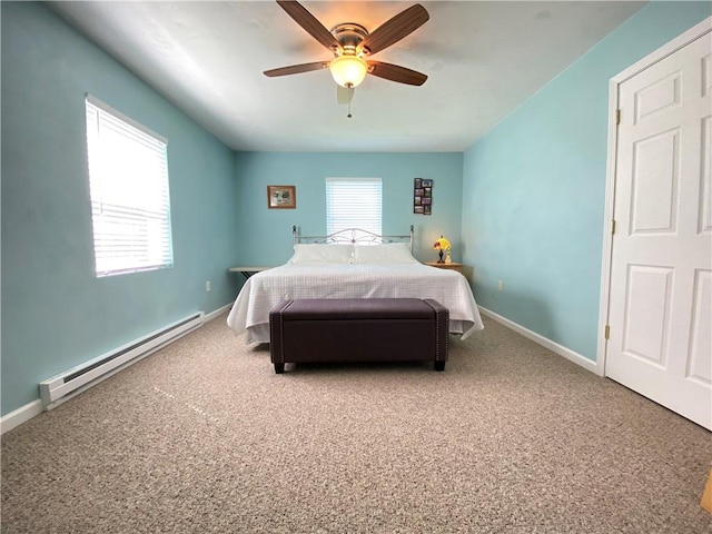 bedroom with carpet flooring, baseboards, and a baseboard heating unit