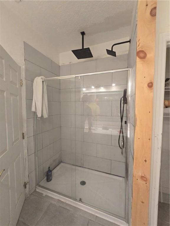 bathroom with tile patterned flooring and a stall shower