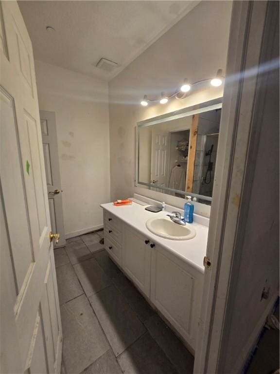 full bathroom with walk in shower, tile patterned flooring, visible vents, and vanity