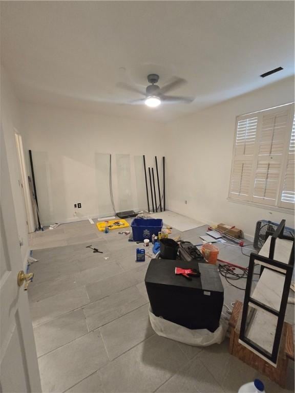 empty room featuring tile patterned flooring and ceiling fan