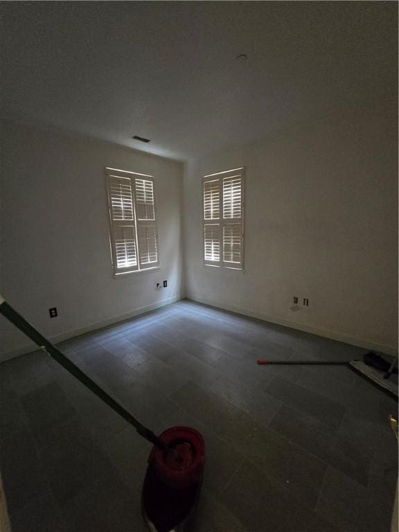 spare room featuring baseboards