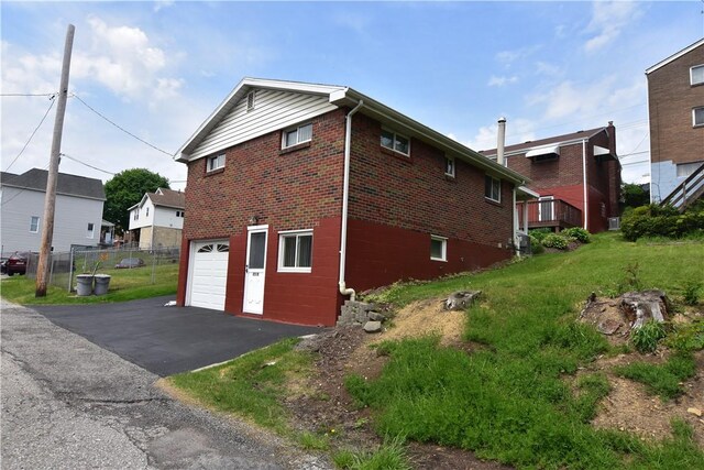 851REAR Florence Ave, Rear, East Mckeesport, PA 15035 - view of side of property with aphalt driveway, fence, an attached garage, and brick siding