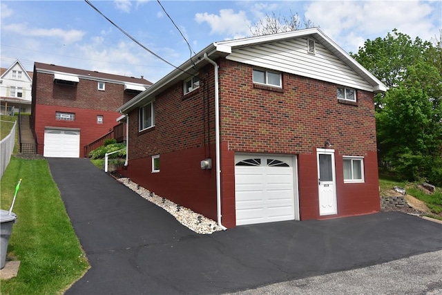 851REAR Florence Ave, Rear, East Mckeesport, PA 15035 - view of property exterior with driveway, brick siding, and an attached garage