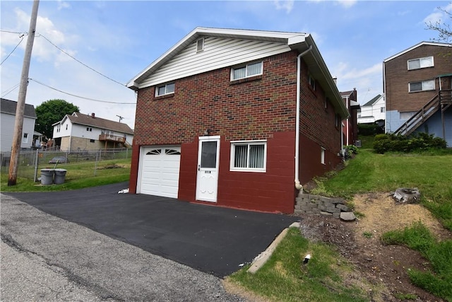851REAR Florence Ave, Rear, East Mckeesport, PA 15035 - exterior space featuring aphalt driveway, fence, a garage, and brick siding