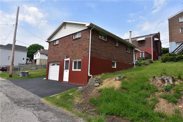 851REAR Florence Ave, Rear, East Mckeesport, PA 15035 - view of side of property with driveway, brick siding, a garage, and fence