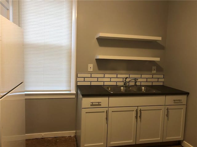617 Center Ave, West View, PA 15229 - kitchen with a sink, open shelves, dark countertops, baseboards, and tasteful backsplash