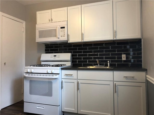 617 Center Ave, West View, PA 15229 - kitchen featuring a sink, white appliances, decorative backsplash, white cabinets, and dark countertops