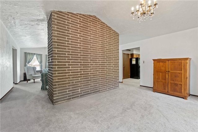 78 Cherryhill Rd, Indiana Boro Ind, PA 15701 - interior space with brick wall, a notable chandelier, a textured ceiling, light colored carpet, and vaulted ceiling