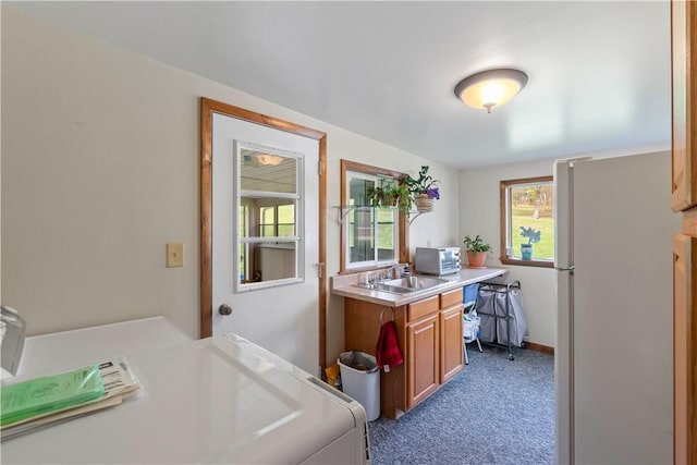 78 Cherryhill Rd, Indiana Boro Ind, PA 15701 - kitchen with a sink, freestanding refrigerator, brown cabinetry, light countertops, and dark colored carpet