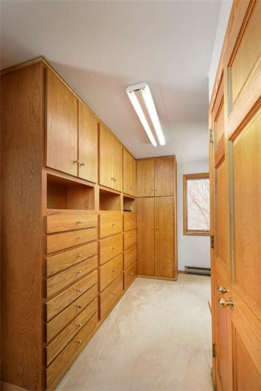 interior space featuring light carpet and a baseboard radiator
