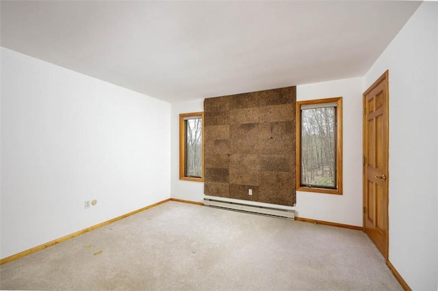 carpeted empty room with baseboards and a baseboard radiator