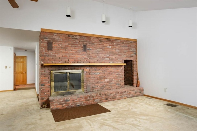 unfurnished living room with visible vents, ceiling fan, a brick fireplace, carpet flooring, and baseboards