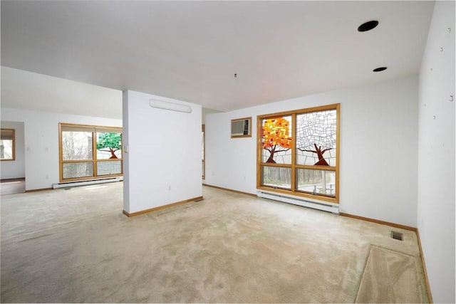 empty room featuring a baseboard heating unit, baseboards, and carpet floors