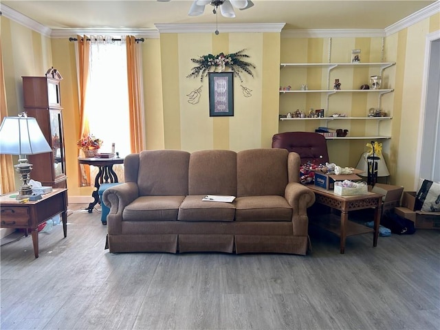 living area featuring ornamental molding, a ceiling fan, and wood finished floors