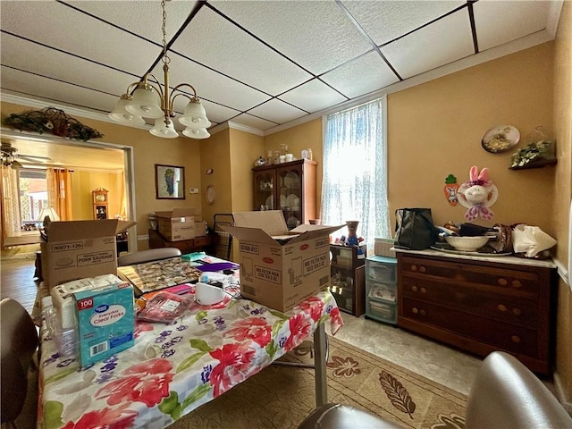 dining area with a paneled ceiling, a notable chandelier, and crown molding