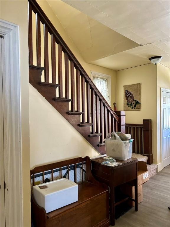 stairway with wood finished floors