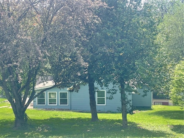 view of property exterior featuring a lawn