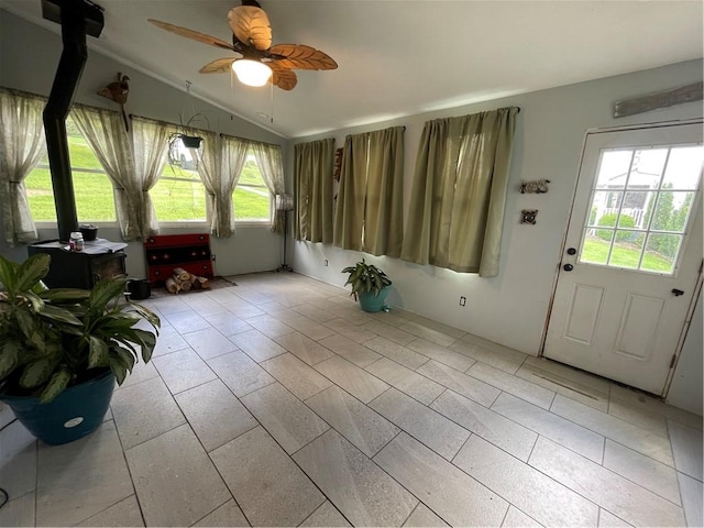 unfurnished room featuring light tile patterned floors, a ceiling fan, and lofted ceiling