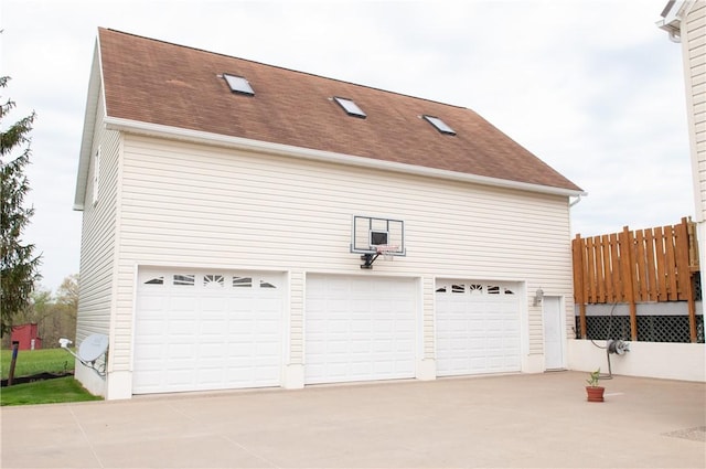 garage featuring concrete driveway