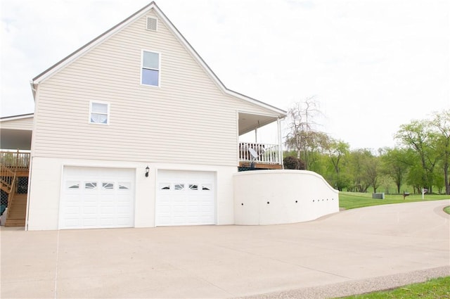 view of property exterior featuring concrete driveway and a garage