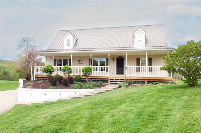 farmhouse featuring a porch, metal roof, and a front yard