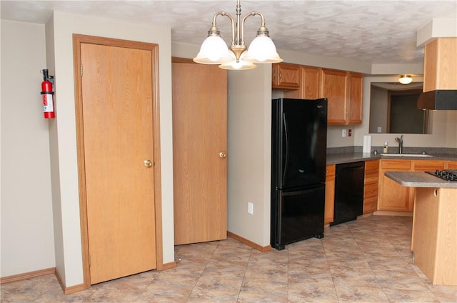 kitchen with pendant lighting, baseboards, a sink, a chandelier, and black appliances