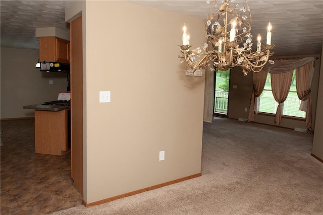unfurnished dining area with baseboards, an inviting chandelier, and carpet