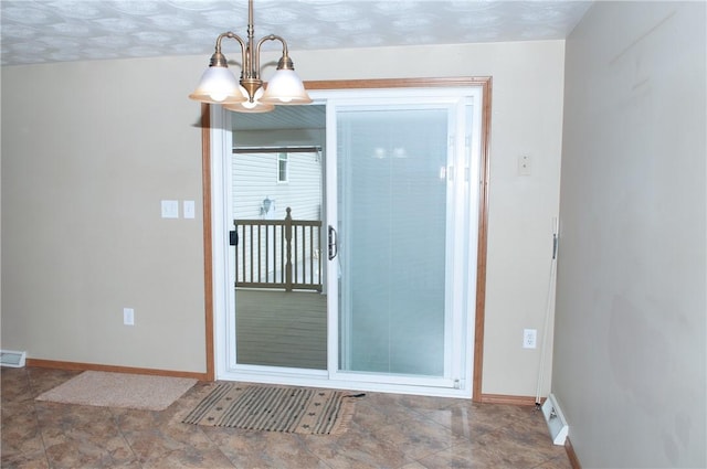 interior space with a chandelier, baseboards, and visible vents