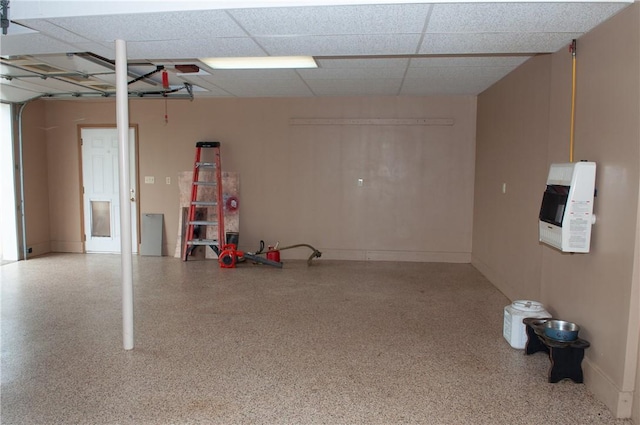 garage with baseboards and heating unit