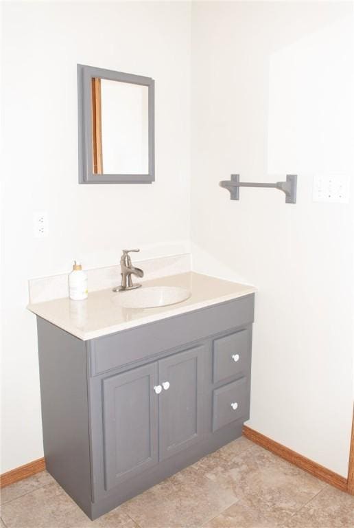 bathroom featuring baseboards and vanity