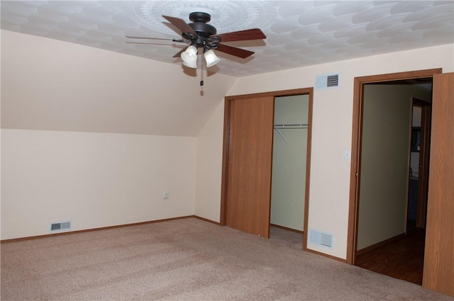 additional living space with light colored carpet, visible vents, lofted ceiling, and a ceiling fan