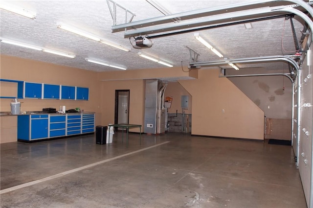 garage with electric panel, a garage door opener, and heating unit