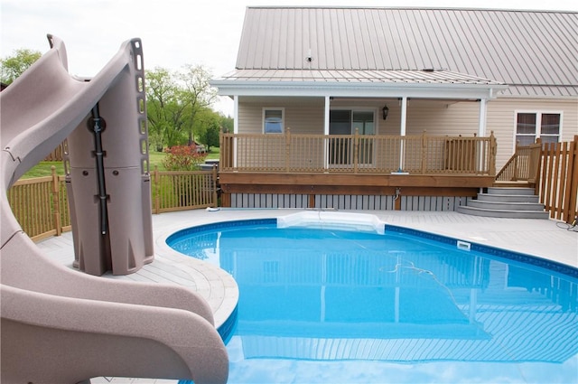 view of swimming pool featuring a wooden deck and a fenced in pool