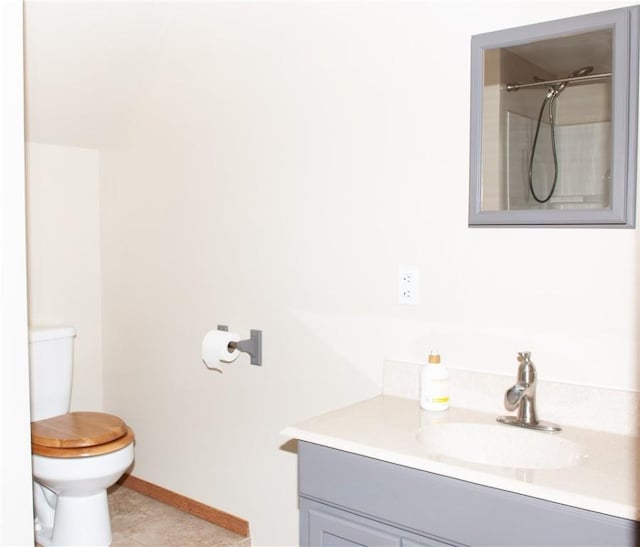 full bath with toilet, baseboards, walk in shower, tile patterned floors, and vanity