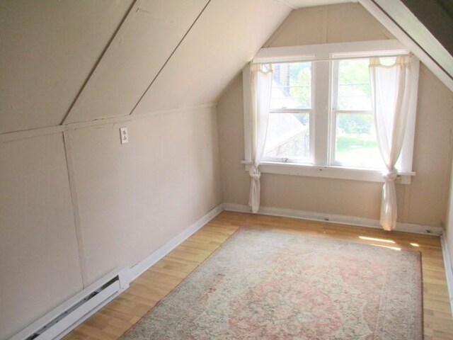 400 12th St, New Brighton, PA 15066 - additional living space with lofted ceiling, baseboards, light wood-type flooring, and a baseboard heating unit