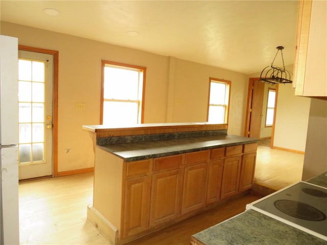 595 Amity Ridge Rd, Amwell, PA 15311 - kitchen featuring light wood-style flooring, stove, dark countertops, and a kitchen island