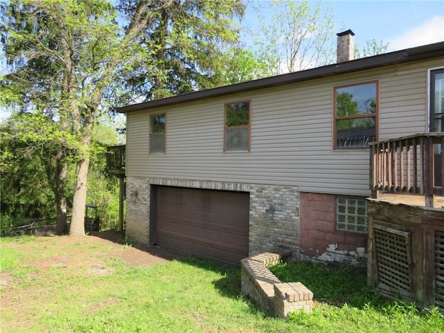 595 Amity Ridge Rd, Amwell, PA 15311 - view of home's exterior featuring an attached garage, a chimney, and brick siding