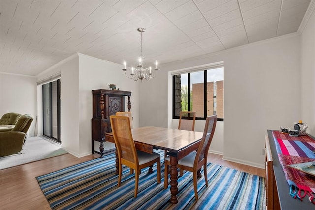 72 Linden Pl Unit 22, Sewickley, PA 15143 - dining room featuring crown molding, a notable chandelier, baseboards, and light wood-style floors
