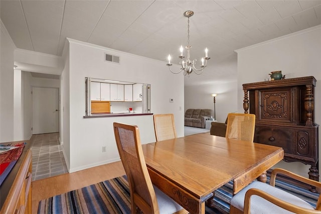 72 Linden Pl Unit 22, Sewickley, PA 15143 - dining area with ornamental molding, an inviting chandelier, visible vents, and light wood-style flooring