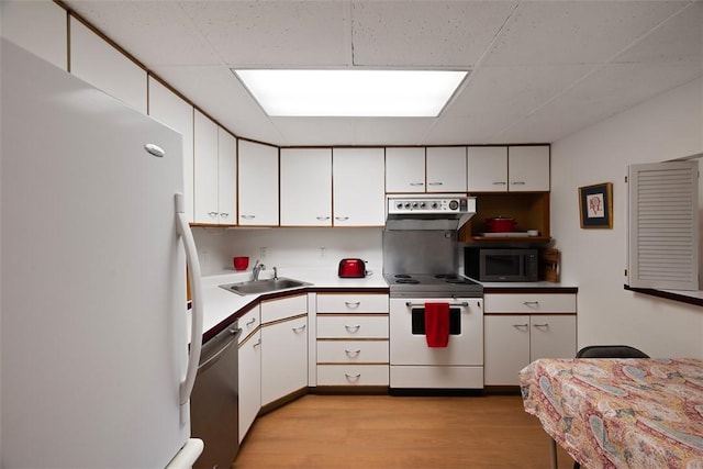 72 Linden Pl Unit 22, Sewickley, PA 15143 - kitchen with light wood-style flooring, a sink, white cabinetry, a paneled ceiling, and stainless steel appliances