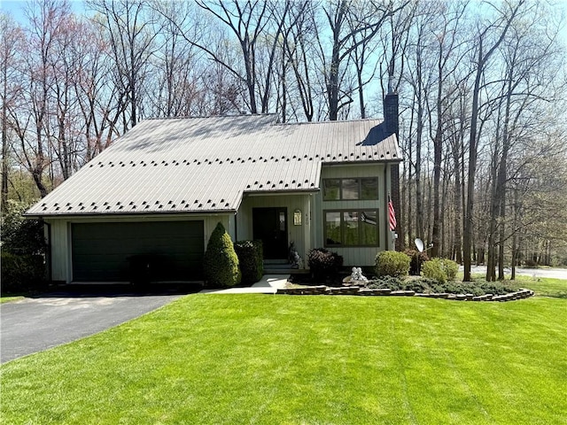 420 Edgewood Ave, White Twp Ind, PA 15701 - view of front of home with metal roof, aphalt driveway, a chimney, and a front yard