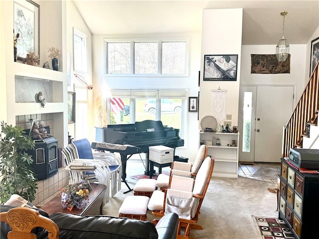 420 Edgewood Ave, White Twp Ind, PA 15701 - carpeted living room featuring a wood stove, stairway, and high vaulted ceiling