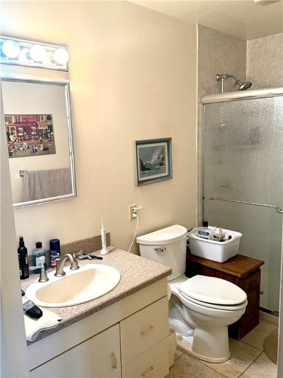 420 Edgewood Ave, White Twp Ind, PA 15701 - full bathroom with a stall shower, vanity, toilet, and tile patterned flooring