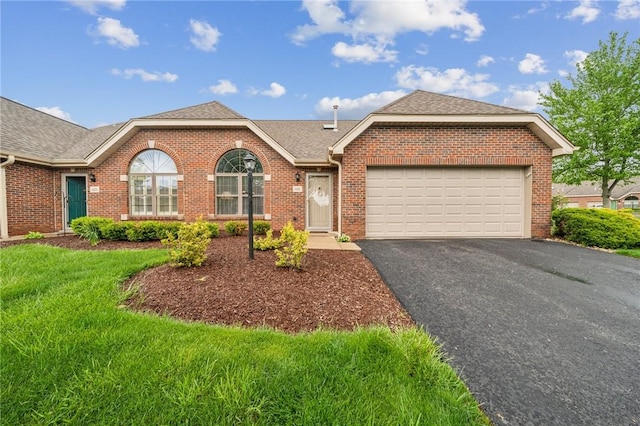 ranch-style house with brick siding, driveway, a garage, roof with shingles, and a front lawn